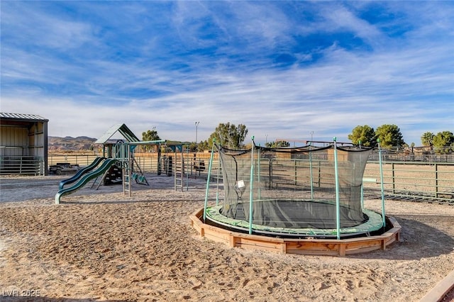 view of jungle gym featuring a trampoline