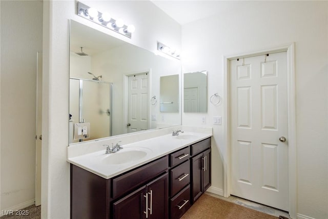 bathroom featuring vanity and a shower with shower door