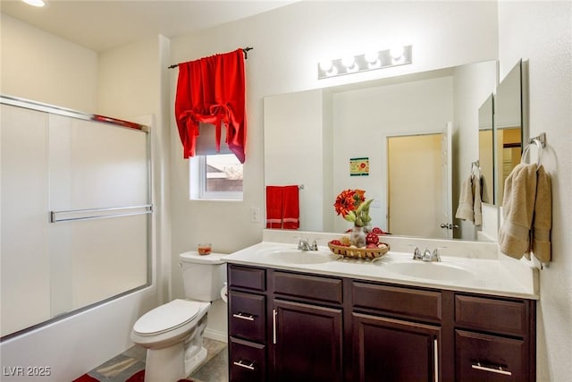 full bathroom with vanity, toilet, and bath / shower combo with glass door