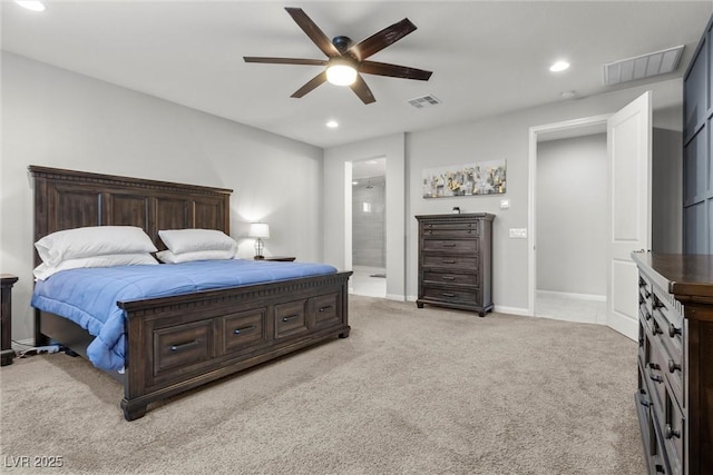 bedroom with light colored carpet, ensuite bath, and ceiling fan