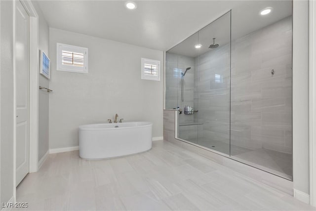 bathroom featuring separate shower and tub, tile patterned floors, and a healthy amount of sunlight