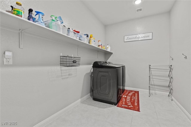 clothes washing area featuring independent washer and dryer and light tile patterned floors