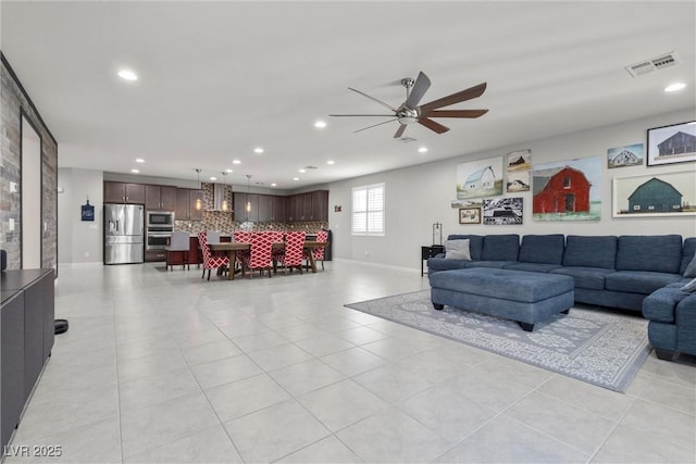 living room featuring ceiling fan and light tile patterned floors