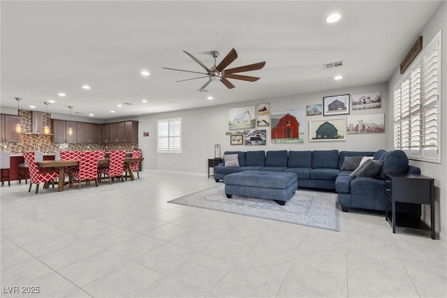 tiled living room featuring ceiling fan