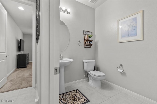 bathroom featuring tile patterned flooring and toilet