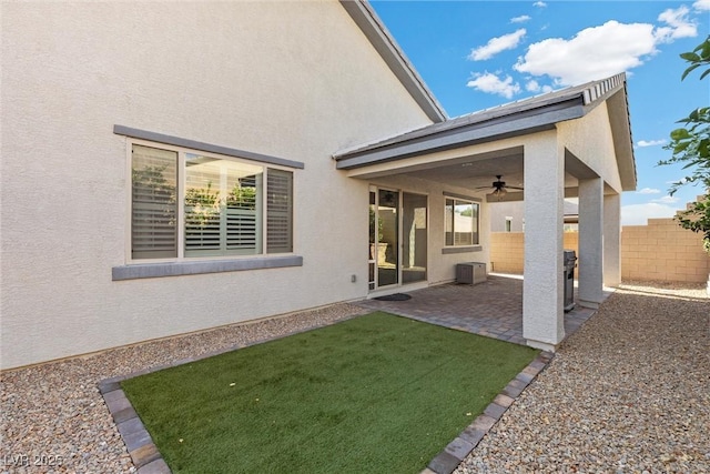 rear view of house with a patio, ceiling fan, a lawn, and central air condition unit