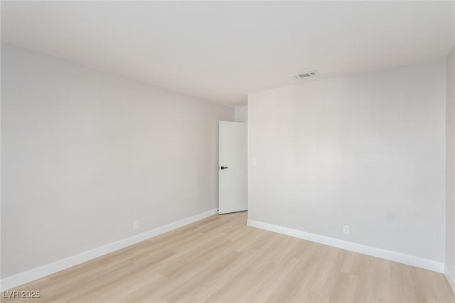 spare room with light wood-type flooring