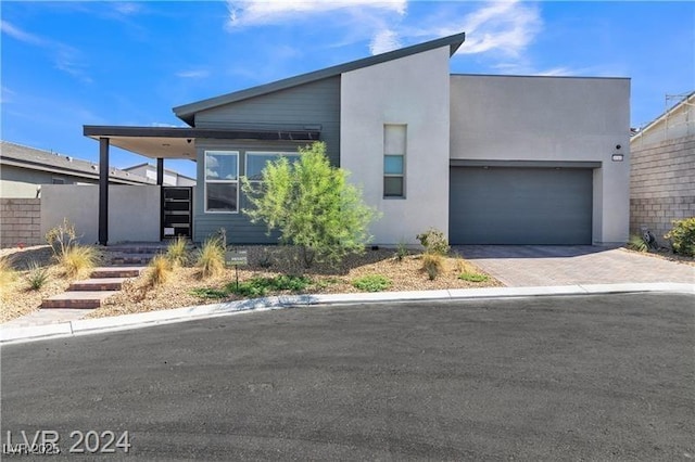 10301 Fairview Ridge Ct, Las Vegas, NV 89166 - contemporary home featuring decorative driveway, an attached garage, and stucco siding