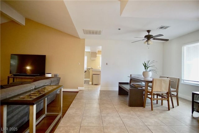 tiled dining space featuring lofted ceiling with beams and ceiling fan