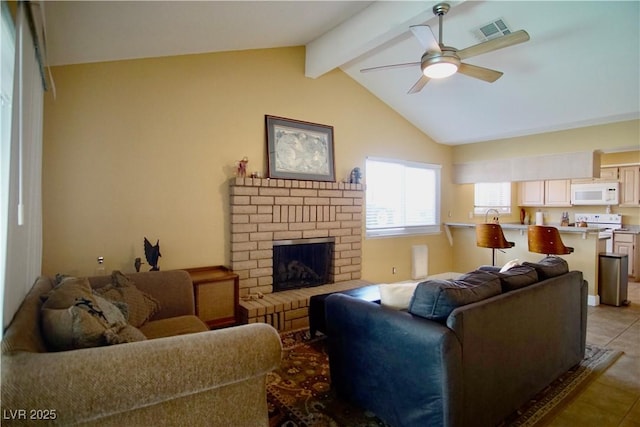 tiled living room featuring sink, a fireplace, lofted ceiling with beams, and ceiling fan