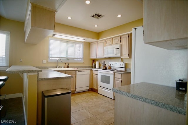 kitchen with sink, light tile patterned floors, kitchen peninsula, light brown cabinets, and white appliances