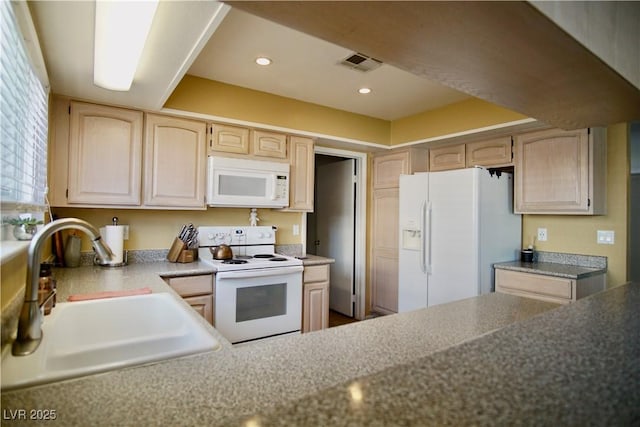 kitchen with sink, light brown cabinets, and white appliances