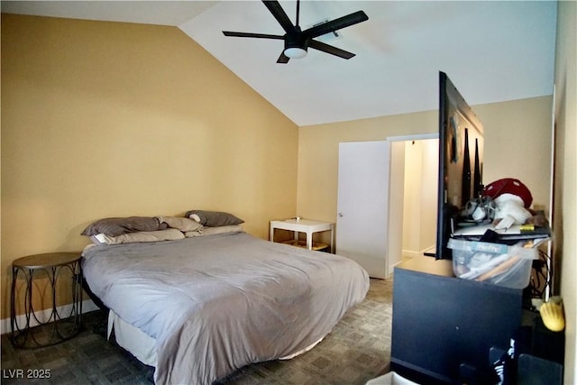 bedroom with vaulted ceiling, ceiling fan, and carpet flooring