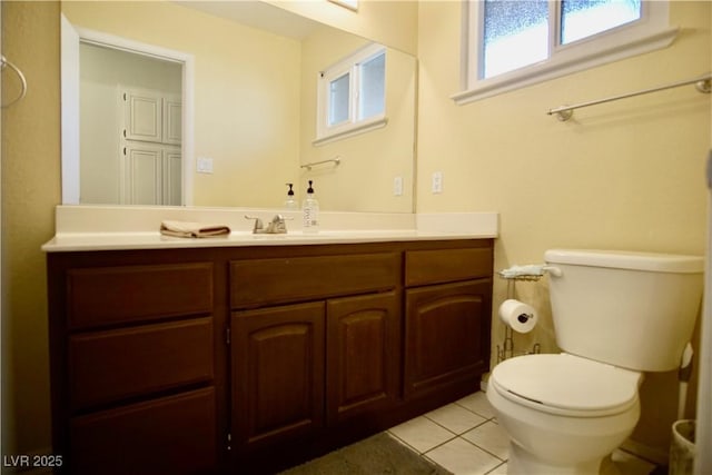 bathroom featuring tile patterned floors, toilet, and vanity