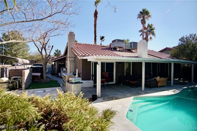 back of property with an outdoor living space and a patio area