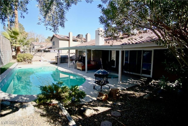 view of swimming pool featuring a patio and an outdoor fire pit