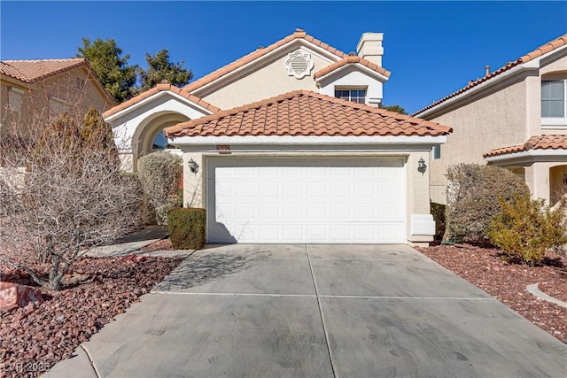 mediterranean / spanish house featuring a garage