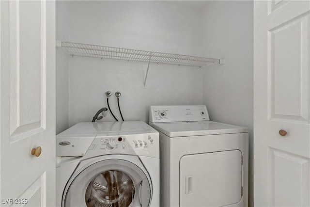 washroom with washing machine and dryer