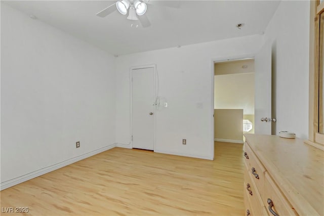 unfurnished bedroom with ceiling fan and light hardwood / wood-style floors