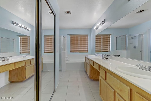 bathroom with tile patterned flooring, vanity, and independent shower and bath