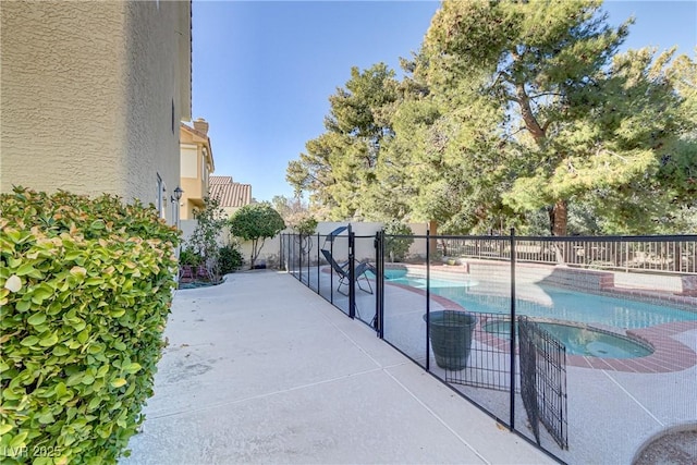 view of swimming pool with an in ground hot tub and a patio