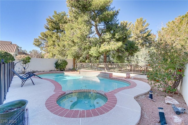 view of swimming pool with an in ground hot tub