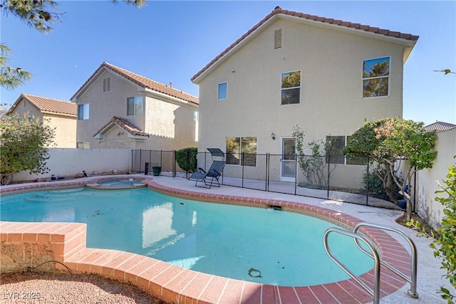 view of pool with an in ground hot tub