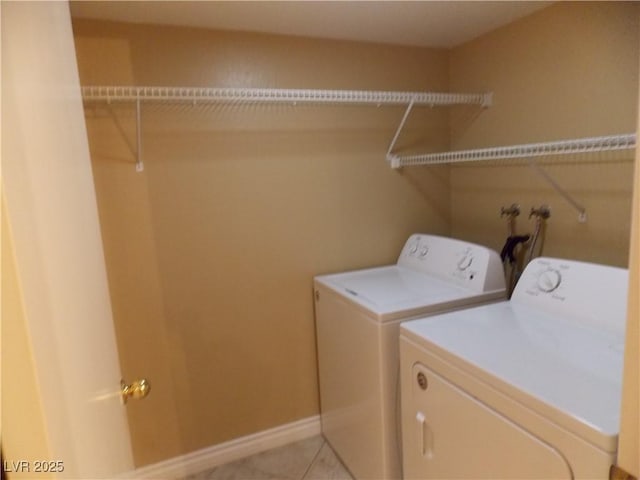 laundry room featuring independent washer and dryer and light tile patterned floors