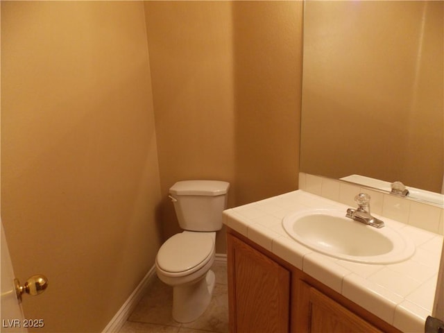 bathroom featuring tile patterned floors, vanity, and toilet