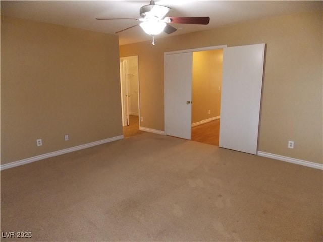 unfurnished bedroom featuring ceiling fan and light colored carpet