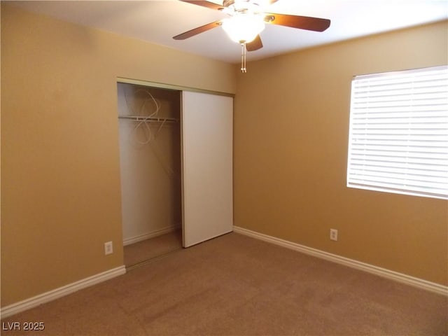 unfurnished bedroom with carpet, a closet, and ceiling fan