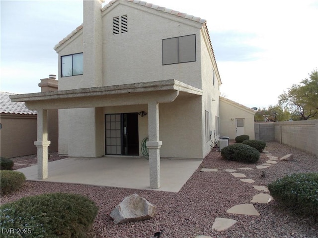 rear view of house featuring a patio area and cooling unit