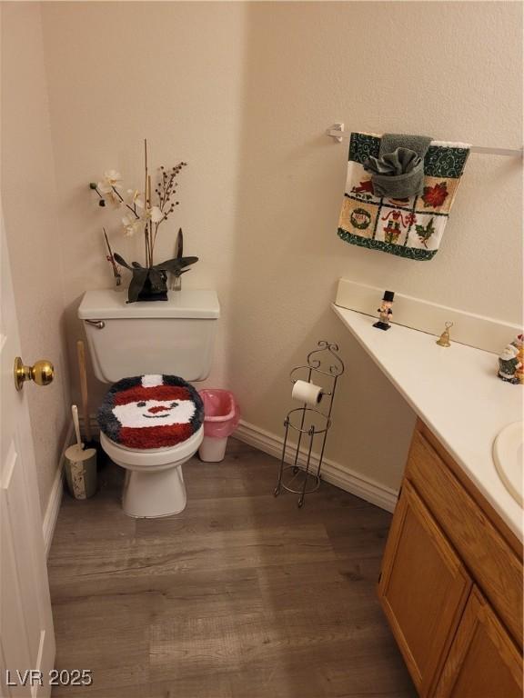 bathroom with vanity, hardwood / wood-style floors, and toilet