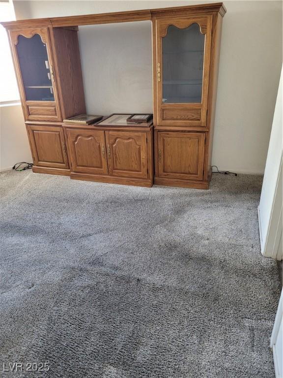 unfurnished living room featuring light carpet