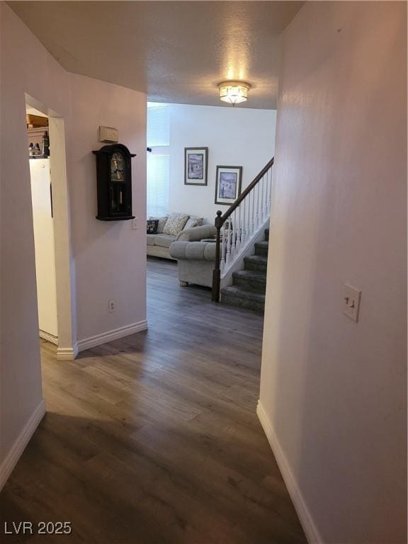 hallway with dark hardwood / wood-style floors