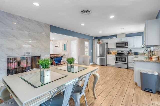 kitchen featuring backsplash, sink, white cabinets, and stainless steel appliances