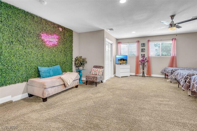 bedroom with a textured ceiling, carpet floors, and ceiling fan