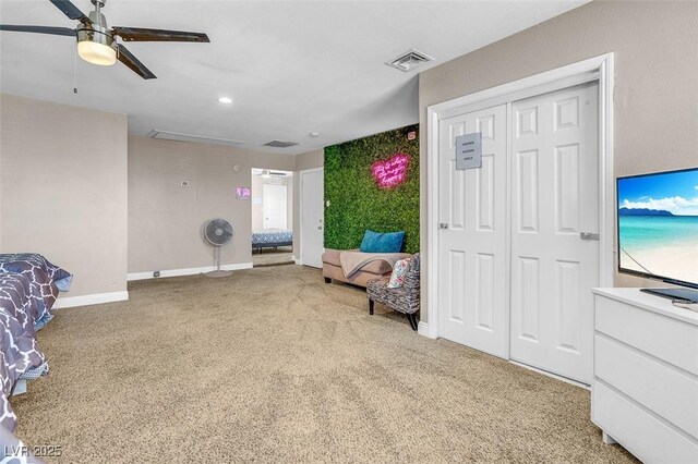 living area featuring carpet flooring and ceiling fan