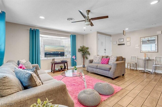 living room featuring light wood-type flooring and ceiling fan