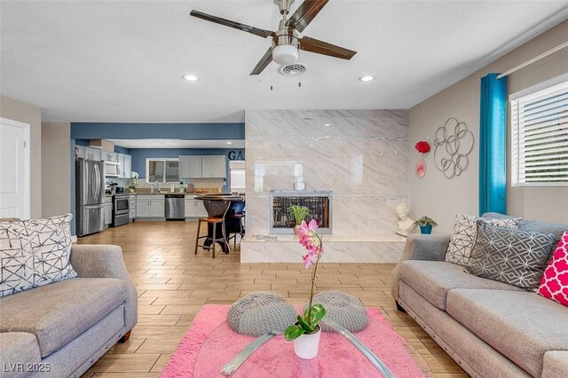 living room with ceiling fan and sink