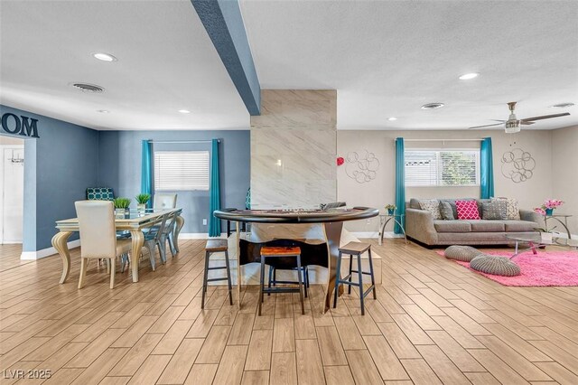 dining room featuring ceiling fan and a textured ceiling