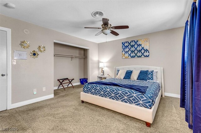 carpeted bedroom with a closet and ceiling fan