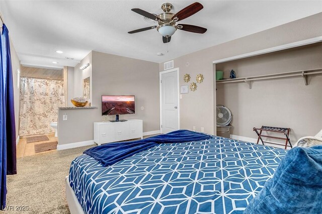 carpeted bedroom featuring ceiling fan, a closet, and ensuite bathroom