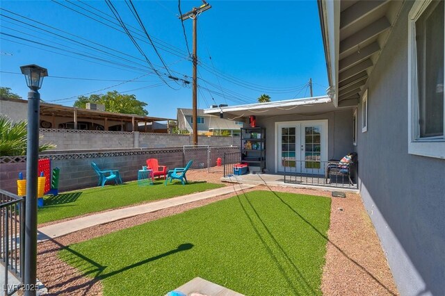 view of yard featuring french doors