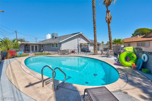 view of swimming pool featuring cooling unit and a patio