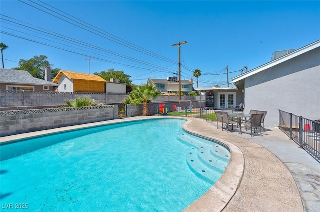 view of pool featuring french doors and a patio