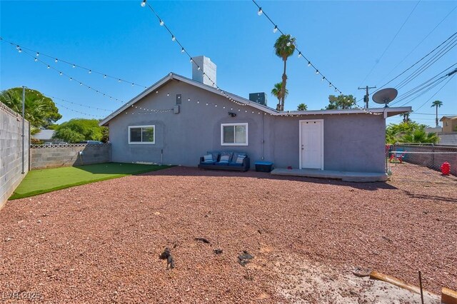 rear view of house with central AC unit