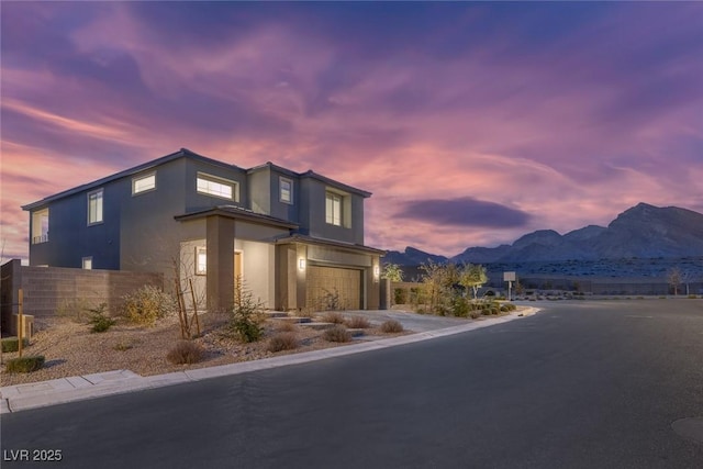 view of front of house featuring a garage and a mountain view