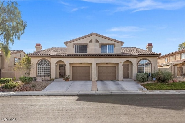 mediterranean / spanish home featuring a garage