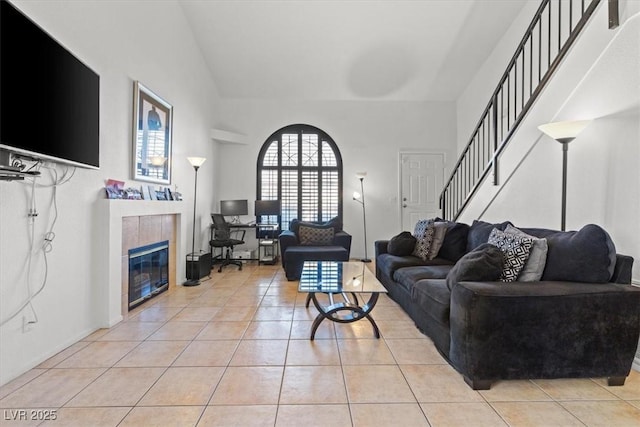 living room with light tile patterned floors and a tiled fireplace